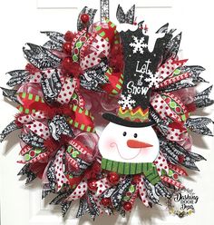 a christmas wreath with a snowman on it