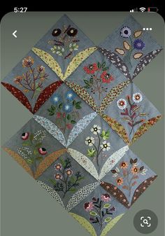 the app is displaying an image of several different flowers and leaves on gray fabric, which are