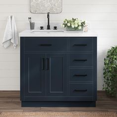 a bathroom with a sink, mirror and rug