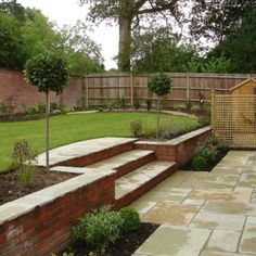 an outdoor garden with steps leading to the back yard