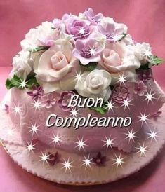 a birthday cake with flowers and the words born compleanoo