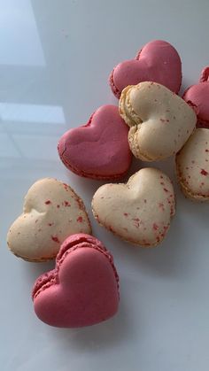 some heart shaped cookies are on a white plate