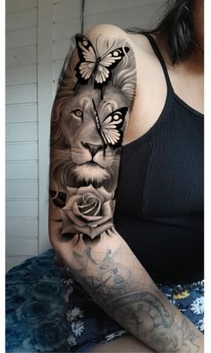 a woman with a tattoo on her arm has a lion and roses tattooed on it