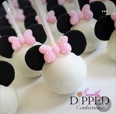 minnie mouse cake pops with pink bows on them