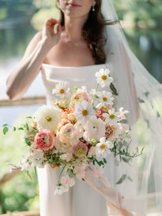 a woman in a white dress holding a bouquet of flowers