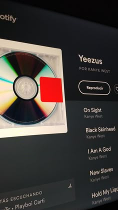 a computer screen with a cd on it's side and the words yeezus written in red