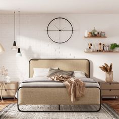 a bedroom with white brick walls and wooden flooring, a large bed in the center