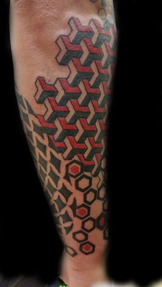 a man's leg with an abstract tattoo design on it