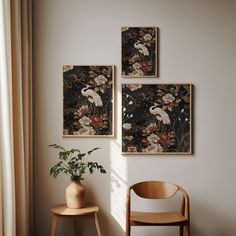 three paintings hang on the wall next to a chair and vase with a plant in it