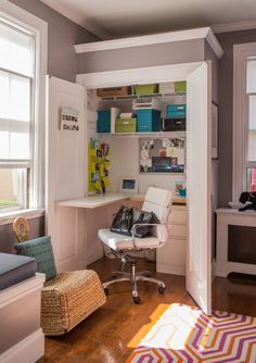 a room with a desk, chair and shelves on the wall next to a window