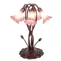 a pink flower lamp with three petals on it's base and one light is turned on