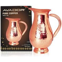 the copper pitcher is next to its box