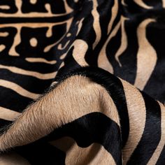 an animal print fabric with black and brown stripes