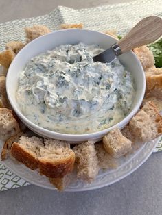 a white plate topped with bread and dip