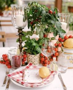 the table is set with fruit and wine glasses