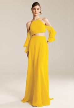 a woman wearing a yellow dress with one shoulder and two pieces of clothing on it