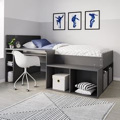 a bedroom with a bed, desk and chair next to two pictures on the wall