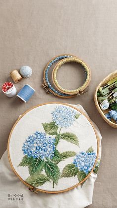 a table topped with blue flowers and bracelets