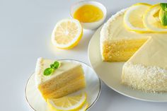 a piece of cake on a plate with lemon slices