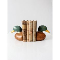 a wooden duck sitting on top of three books