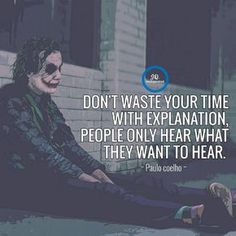 a joker sitting on the ground next to a building with a quote above it that reads, don't waste your time with explanation people only hear what they want to hear