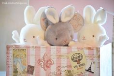 three stuffed animals are sitting in a box