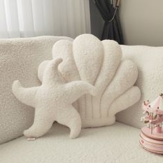 a stuffed animal is sitting on a white couch