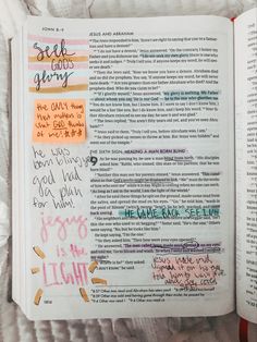 an open bible with handwritten notes on the pages and colored lettering in pink, orange, blue, yellow