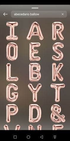 the alphabet is made out of balloons and has been placed on top of an iphone