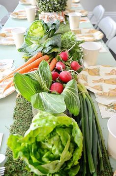 a long table filled with lots of fresh vegetables