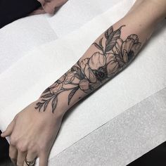 a woman's arm with flowers on it