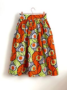 "Lime Green & Orange high waist full gathered skirt. Perfect for casual outfits and special ocasions with pair of trainers or high heels. Elastic at the back of waist.  Two side pockets. Midi length 70 cm + 5 cm waistband. Handmade in UK.  HOW TO CHOOSE A SIZE ?   Using a measuring tape, measure the smallest part of your waist.  SIZE CHART: (CM) XS - W: 66 CM S - W: 70 CM M - W: 74 CM  L - W: 78 CM  XL - W: 82 CM  CARE INSTRUCTIONS: Hand wash only, do not bleach, hang dry, do not tumble dry, press with a cool iron on the reverse side.  Please message me before purchasing so I can check availability. If you wish this skirt in any other fabric, shorter or longer \"send message to seller\" and we can try to make something especially for you." Lime Green And Orange Outfit, Orange Flared Skirt For Spring, High Waist Multicolor Cotton Skirt, Multicolor High Waist Cotton Skirt, High Waist Cotton Gathered Skirt, High Waist Gathered Cotton Skirt, Fitted Orange Cotton Skirt, Orange Fitted Cotton Skirt, Multicolor Gathered Midi Skirt