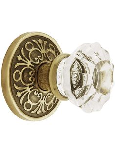 an antique style door handle with glass knob