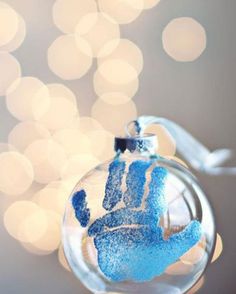 a glass ornament with a blue hand on it