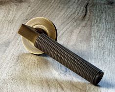 a close up of a metal object on a wooden surface