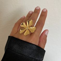 Compare at $38! Save more than 20% when you buy Margo as a set. We are kicking subtle out of the curb with Margo. Flowers rarely go out of style, and this one is for the feminine woman who dares to take flowers beyond spring. This statement earring duo & ring is all the feels. A delicate flower adorned with a dainty white cubic zirconia in the center. Margo is fit for any occassion. Details Waterproof and Tarnish Free Material: Stainless Steel dipped in 18k gold Flower Size: 33mm length & Width