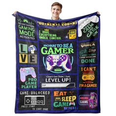 a man is holding up a blanket with video game related items on it and the words'born to be a gamer level up '