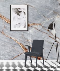 a chair in front of a marble wall with a black and white checkered floor