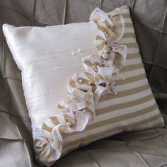 a decorative pillow with ruffled edges on a couch