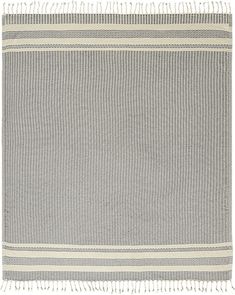 a gray and white rug with fringes