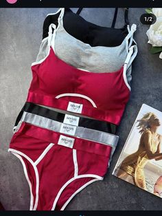 a woman's red and white bathing suit next to a magazine on the ground