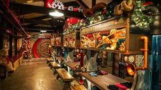 a long row of wooden benches sitting next to each other in front of christmas decorations