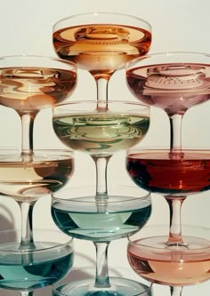 there are many different colored wine glasses in the same glassware, all lined up together