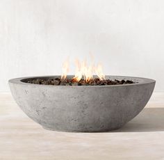 a concrete bowl with fire burning in it