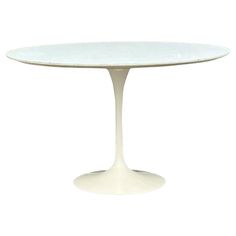 an oval white table with a circular base and glass top, viewed from the front