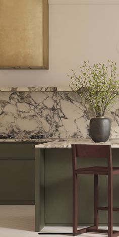 a marble counter top in a kitchen with two wooden chairs and a vase on it