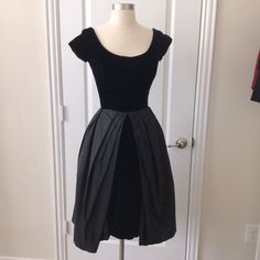 Beautiful Vintage Black Cocktail Dress Scoop Neckline Cap Sleeves Poofy Skirt Velvet And Taffeta Label Neiman Marcus Bust 32-33” Waist 24” Bodice Length 15” Full Length 40” Fastens With Metal Zipper Up Center Back. Fully Lined. Net Skirting Underneath As Well. Very Good Condition! Party Dress With Box Pleat And Full Skirt, Vintage Fit And Flare A-line Dress For Party, Black Fitted Dress For Vintage Events, Fitted Black Dress For Vintage Events, Fitted Pleated Dresses For Vintage Fashion, Fit And Flare A-line Vintage Party Dress, Black Fitted Dress With Full Skirt, Fitted Black Dress In 1950s Style, 1950s Fitted Black Dress