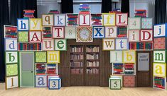 a room with bookshelves and letters on the wall