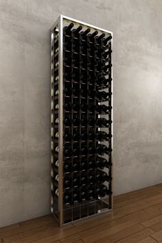 a wine rack with many bottles in it on a wooden floor next to a wall