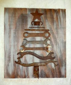 a christmas tree made out of wrenches on a piece of wood with a star above it